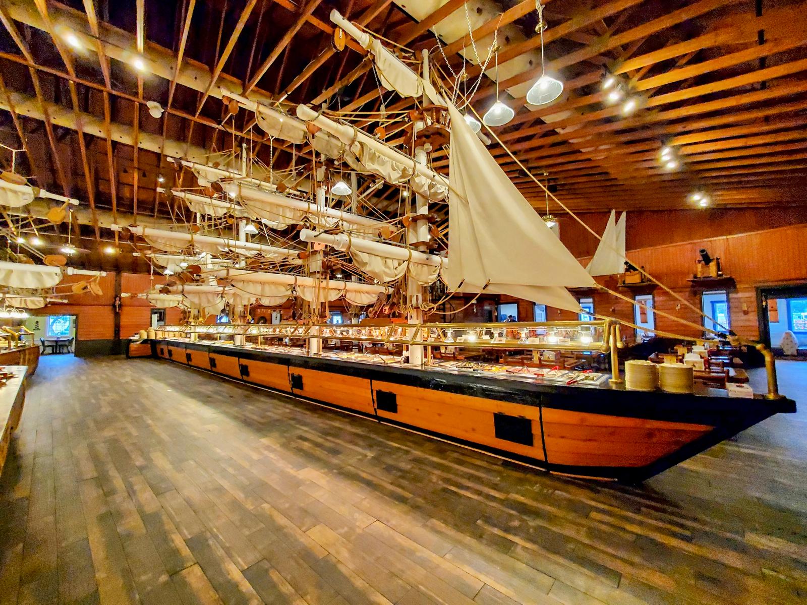 The full-size pirate ship buffet with masts, sails, and wood hull at Pirate's Table